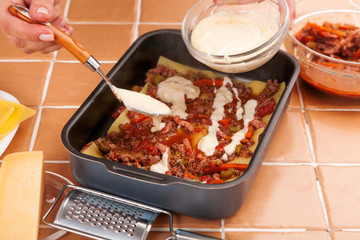 chef prepares meat lasagna