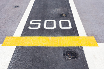 Five hundred metre sign on the road.