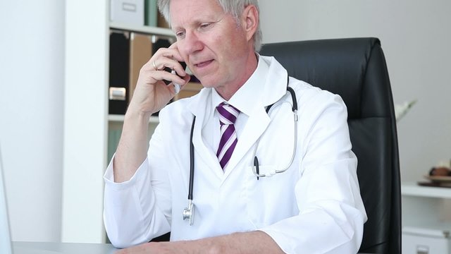 Doctor chatting on his mobile phone 