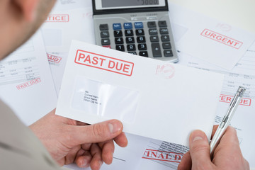 Businessperson Hand With Past Due Envelope