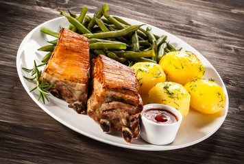 Grilled ribs, boiled potatoes and vegetables
