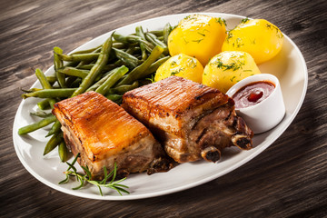 Grilled ribs, boiled potatoes and vegetables