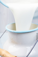 pouring milk from a bucket