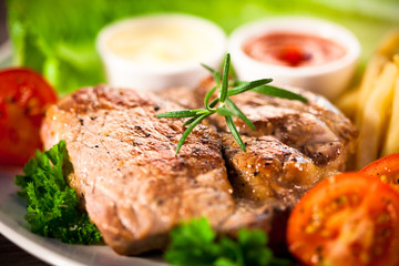 Grilled steaks and vegetable salad