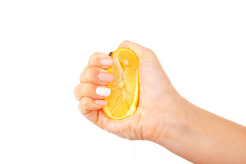 Female hand squeezing lemon isolated on white