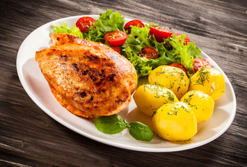 Fried chicken fillet, boiled potatoes and vegetable salad