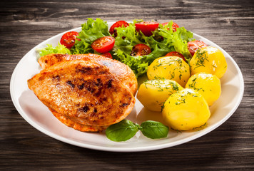 Fried chicken fillet, boiled potatoes and vegetable salad
