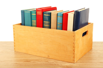 Books in wooden box isolated on white