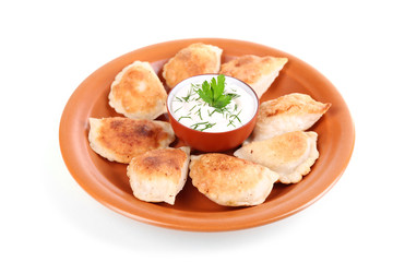 Fried dumplings with onion on plate, isolated on white