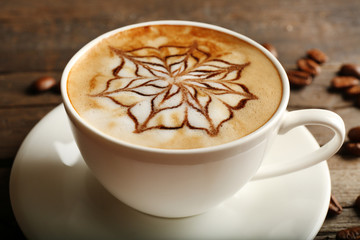Cup of latte art coffee, closeup
