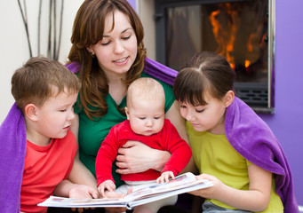 Mother is reading book with children
