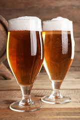 Glasses of beer on wooden background
