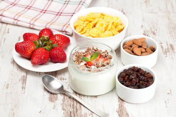 yogurt with berries and breakfast foods, closeup