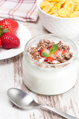 yogurt with berries and breakfast foods, vertical