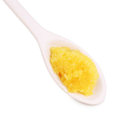 Laboratory spatula with granules isolated on white