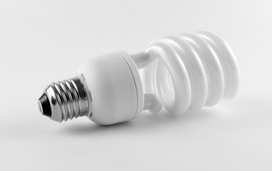 Energy saving fluorescent light bulb on white