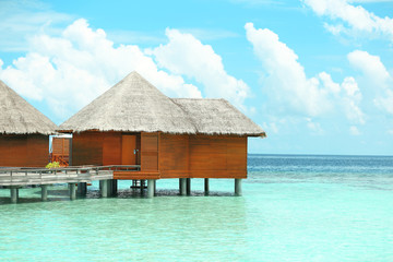 Water villas over blue ocean in Baros Maldives