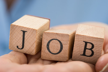 Person Hand With The Word Job On Blocks