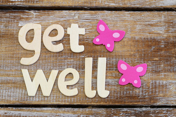 Get well written with wooden letters on rustic wooden surface