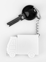 Keys with trinket on light background