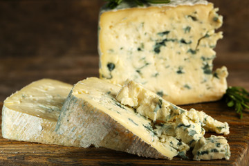 Blue cheese on wooden cutting board. closeup