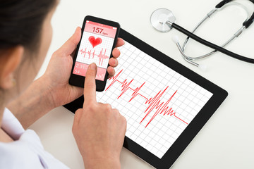 Doctor Looking At App For Health