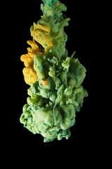 Green and Yellow ink color drop underwater