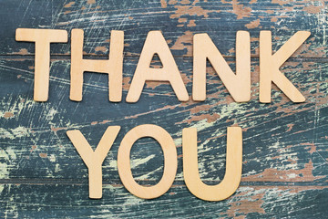 Thank you written with wooden letters on rustic wooden surface © graletta