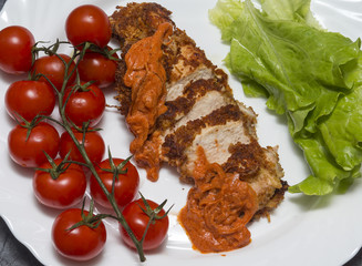 Chicken breast with cherry tomatoes and salad