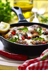 Fish meatball baked in frying pan.