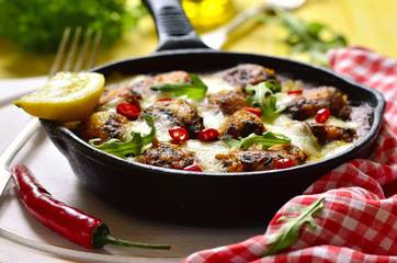 Fish meatball baked in frying pan.