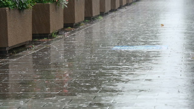 Slowmotion raindrops on the pavement