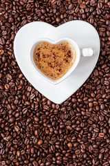 white coffee cup heart shaped with cappucino