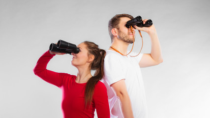 Couple looking through binoculars