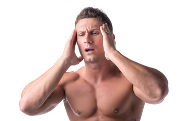 Fototapeta premium Muscular handsome man holding his head with for headache