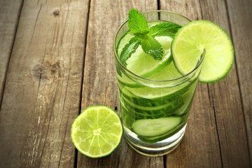 Healthy vitamin water with lime and cucumber against rustic