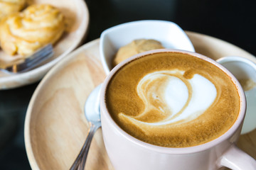 Cup of coffee with heart pattern