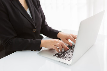 Business woman hand typing on laptop keyboard