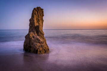Sea stack in the Pacific Ocean at sunset, at El Matador State Be