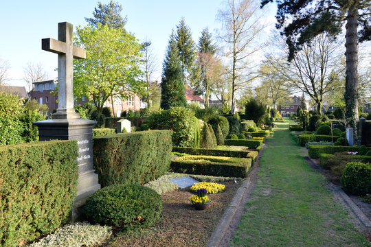 graves headstones and crucifixes of a cemetery in germany