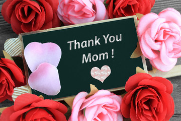 Thank you mom sign on chalkboard with heart and flowers