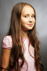 Naklejka premium Beautiful child poses for the camera in studio.Isolated portrait