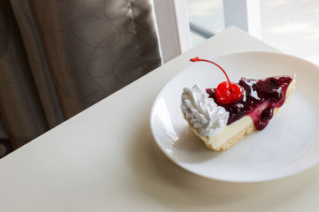 blueberry cheese cake with cherry on top