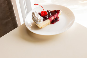 blueberry cheese cake with cherry on top