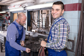 Workmen in repair shop