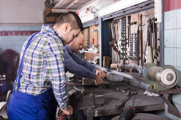 Fototapeta na wymiar Mechanics working at workshop