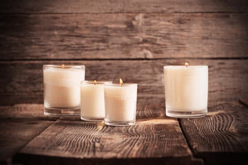 scented candles on old wooden background
