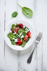 Salad with spinach, strawberry and cheese, view from above