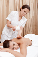 Fototapeta na wymiar Masseur does massage to a woman