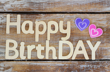 Happy birthday written with wooden letters on rustic wood